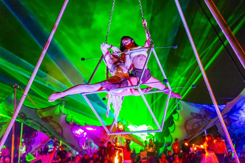 Aerialist under green lasers at Sound Haven 2026