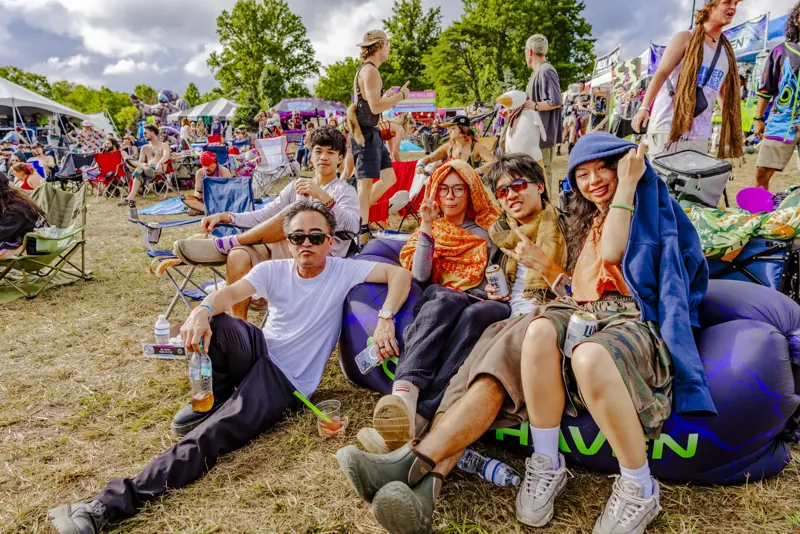 Friends piled onto bean bags on the hill at Sound Haven 2026
