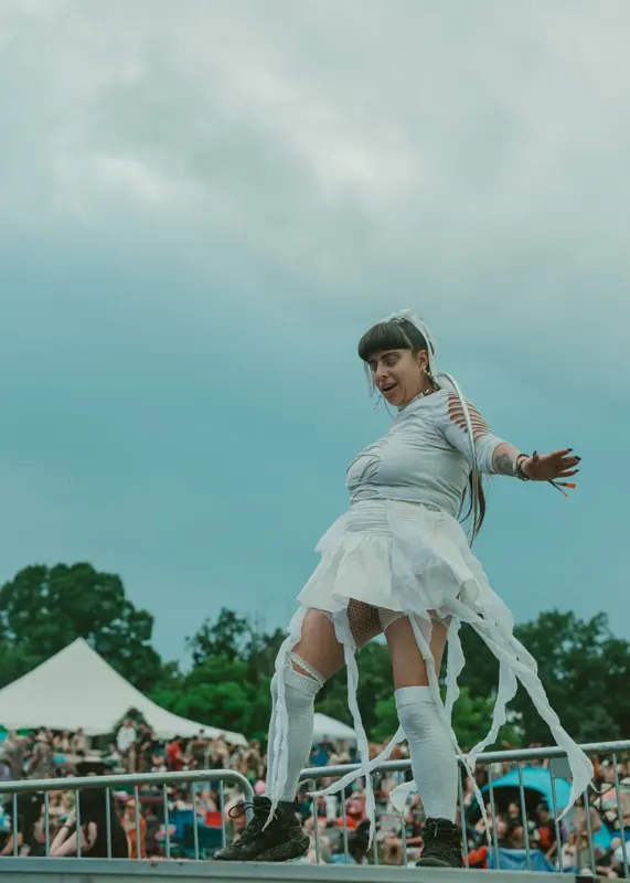 Dancer on the stage platform above the crowd at Sound Haven 2026