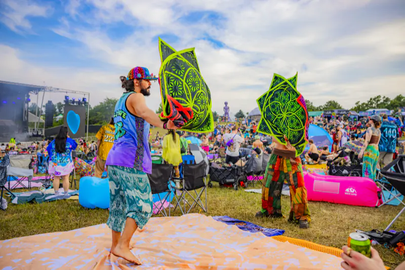 Attendees waving illustrated fans in the crowd at Sound Haven 2026