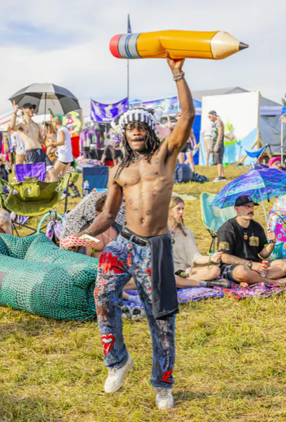 Attendee holding an inflatable pencil above the crowd at Sound Haven 2026