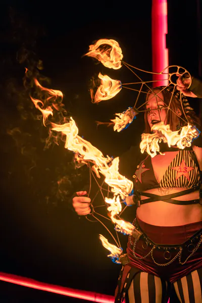 Fire performer spinning lit fans at night during Sound Haven 2026