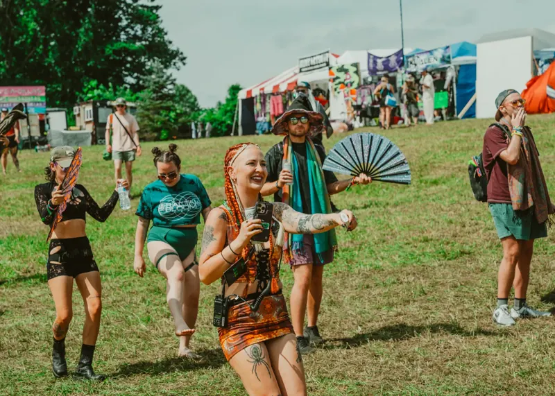 Friends walking the vendor row in costume at Sound Haven 2026